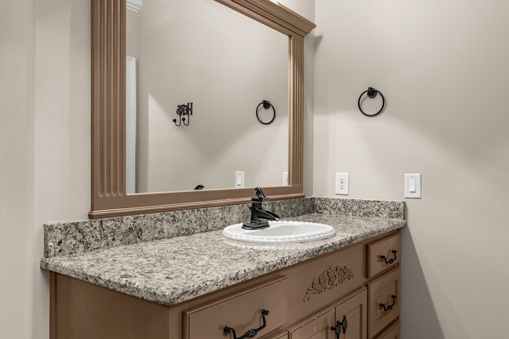 8026 Splendor Way Columbus, GA 31904 - Photo 23 of 44 a bathroom with a granite countertop sink and a mirror