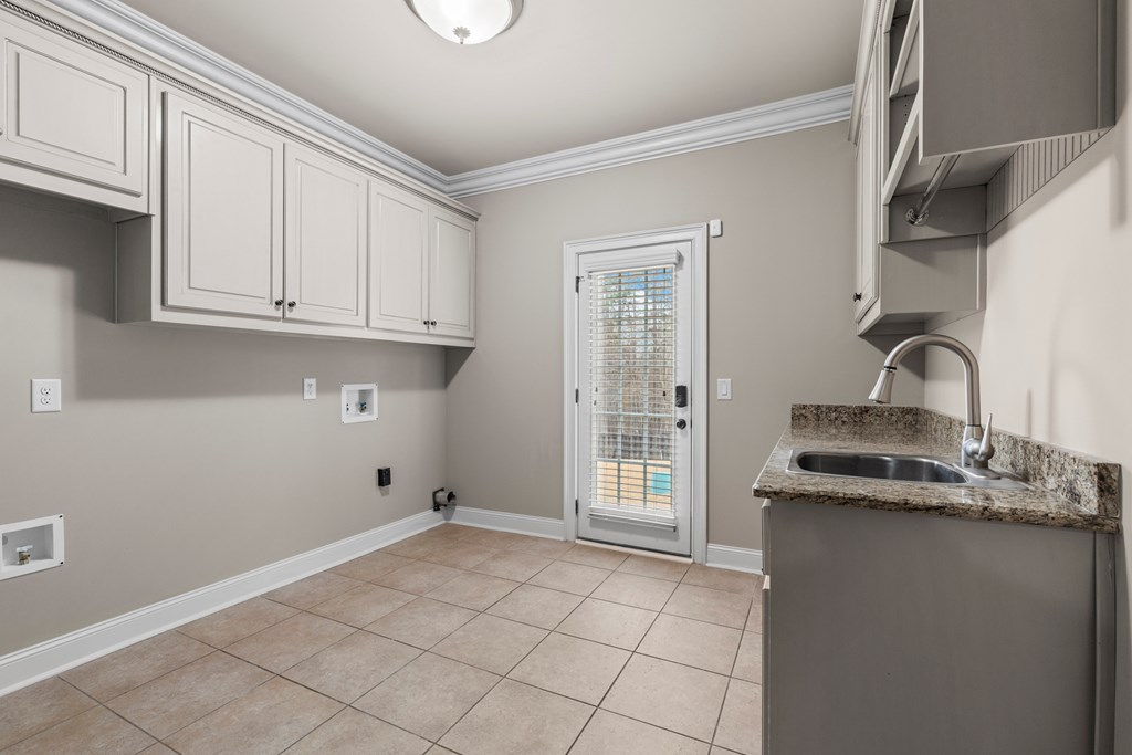 8026 Splendor Way Columbus, GA 31904 - Photo 24 of 44 a kitchen with granite countertop a sink and cabinets