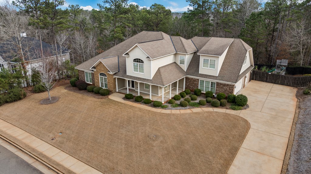 8026 Splendor Way Columbus, GA 31904 - Photo 41 of 44 a view of a white house next to a yard with large trees