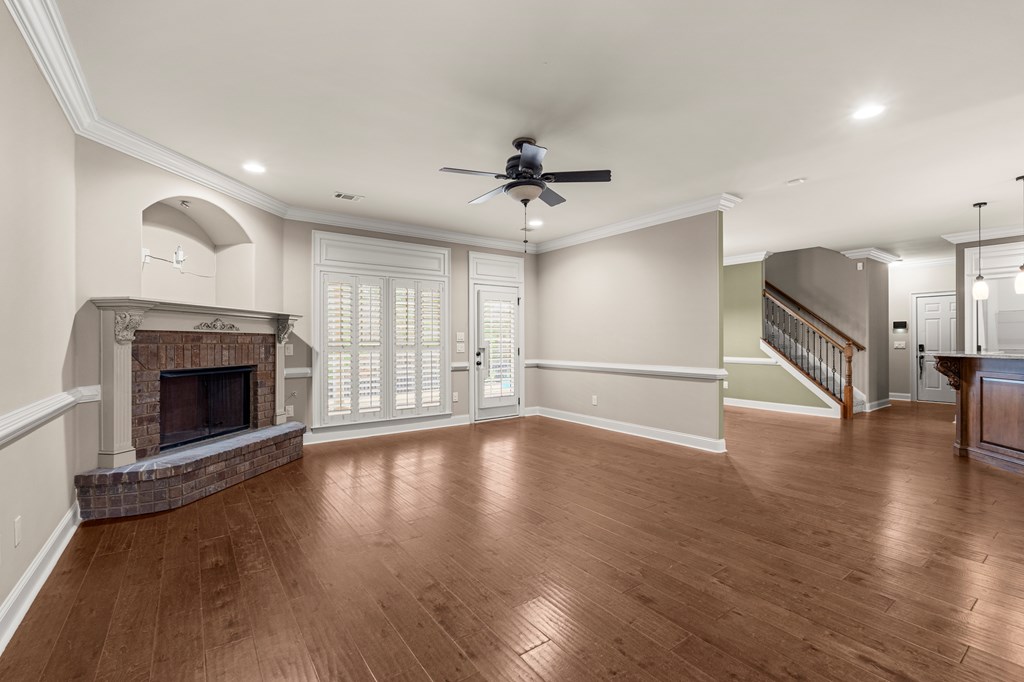 8026 Splendor Way Columbus, GA 31904 - Photo 9 of 44 a view of a livingroom with a fireplace a ceiling fan and windows
