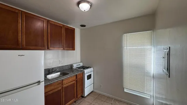 a kitchen with a refrigerator stove and cabinets