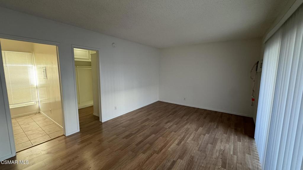 13507 Victory Boulevard, Unit 2 Van Nuys, CA 91401 - Photo 6 of 10 an empty room with wooden floor and windows