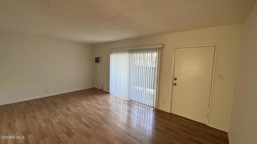 13507 Victory Boulevard, Unit 2 Van Nuys, CA 91401 - Photo 8 of 10 a view of an empty room with wooden floor