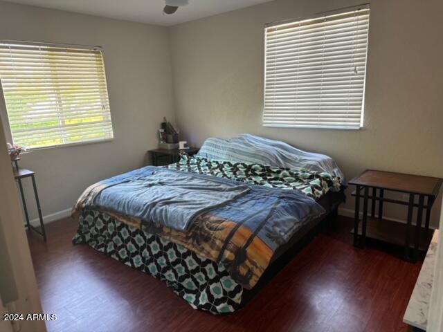 1336 East Mountain View Road, Unit 202 Phoenix, AZ 85020 - Photo 11 of 23 a bedroom with a bed wooden floor and a window