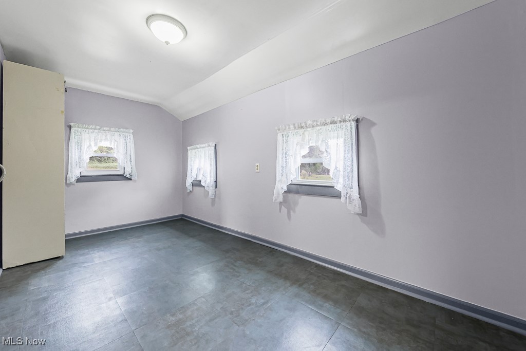 1425 Killian Road Akron, OH 44312 - Photo 18 of 41 Laundry room featuring lofted ceiling and baseboards