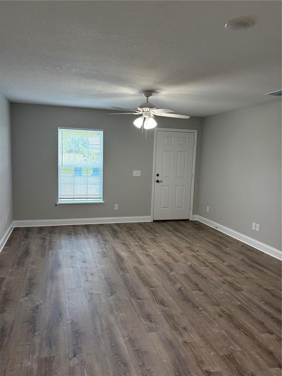 508 2nd Street Southwest Fort Meade, FL 33841 - Photo 9 of 18 an empty room with wooden floor and windows