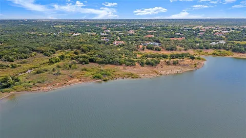 an aerial view of residential houses with outdoor space and ocean view