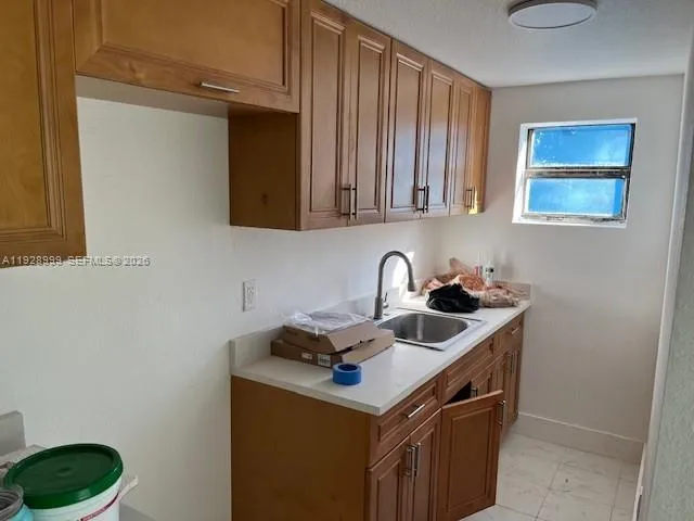 a kitchen with a sink a stove and a microwave