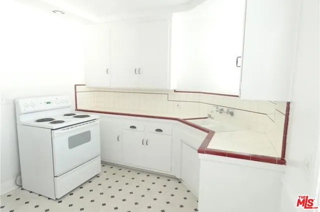 a kitchen with a stove and a refrigerator