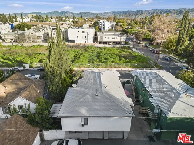 an aerial view of residential houses with outdoor space