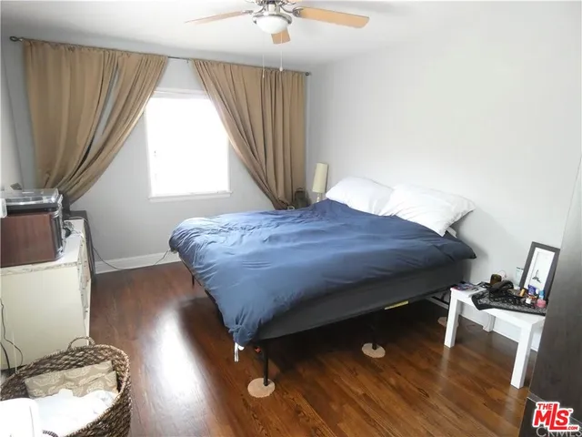 a living room with a bed furniture and a window