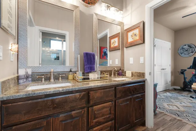 a bed room with a bed a dresser and chair