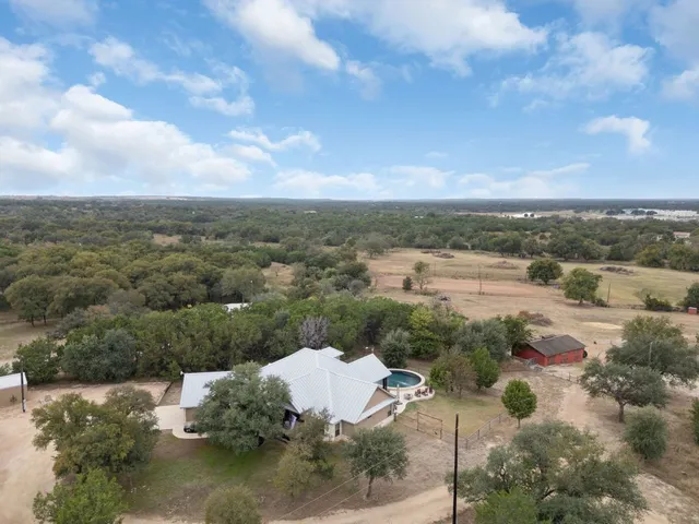 an aerial view of a house with outdoor space