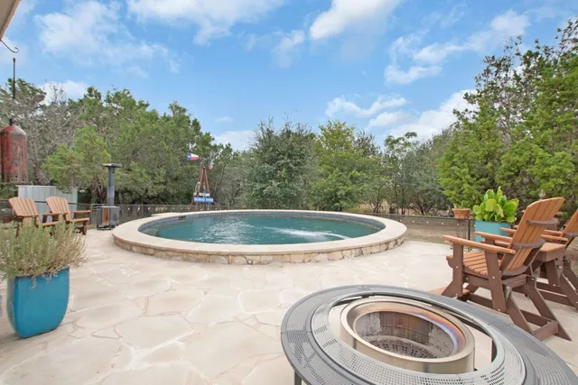 a living room with lots of furniture and kitchen view