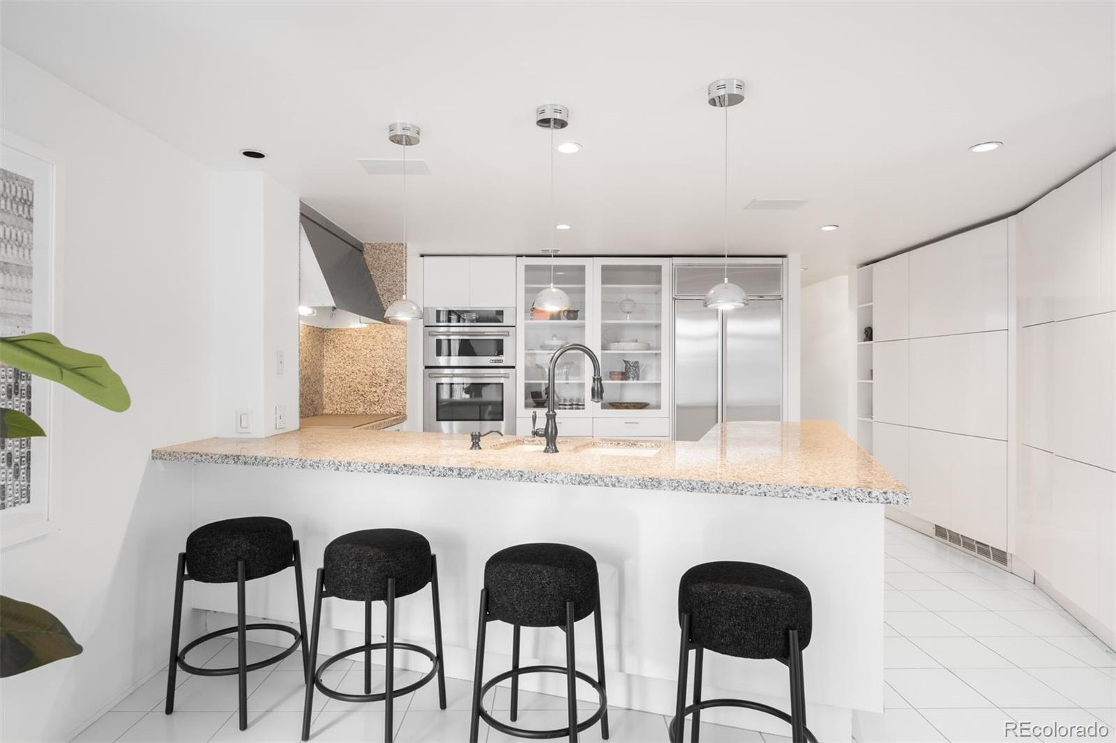 1777 Larimer Street, Unit 710 Denver, CO 80202 - Photo 11 of 47 a dining table with chairs and chandelier