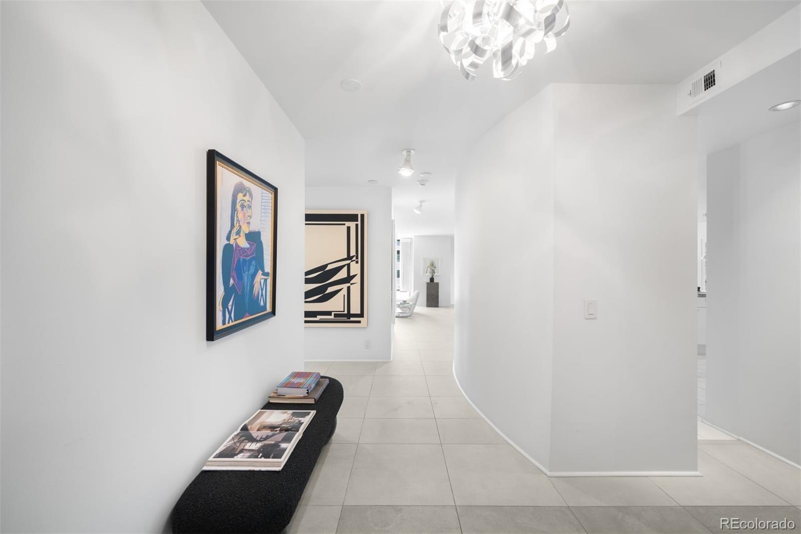 1777 Larimer Street, Unit 710 Denver, CO 80202 - Photo 20 of 47 a view of a hallway with paintings on the wall