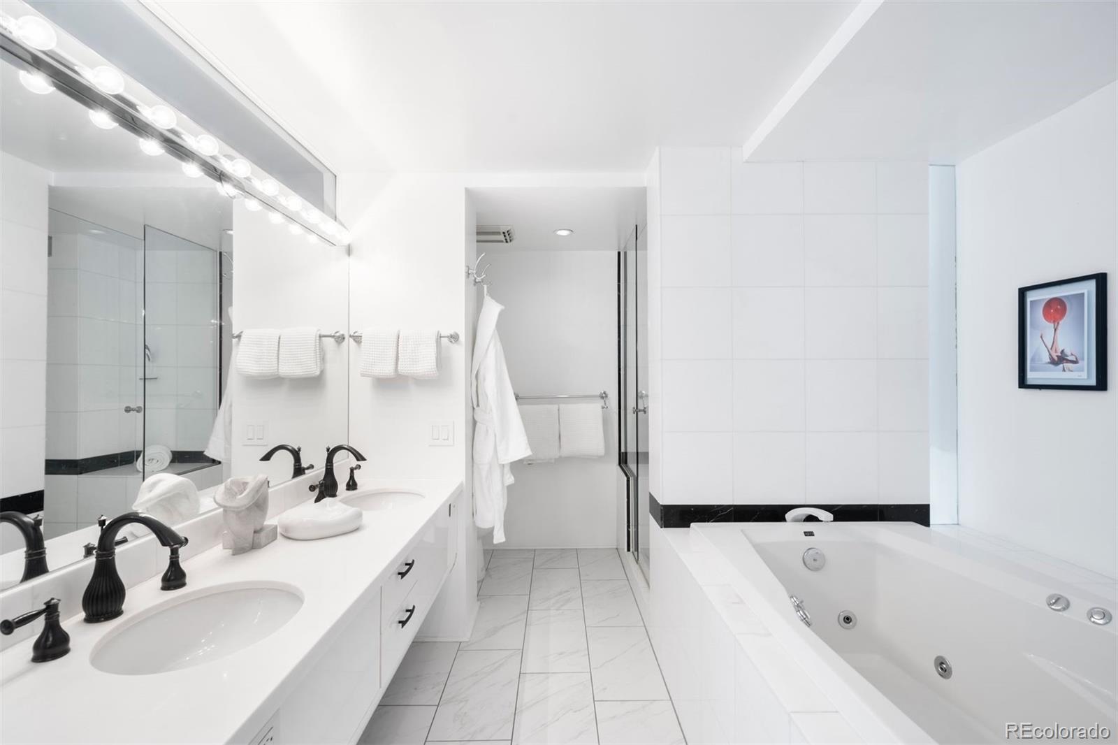 1777 Larimer Street, Unit 710 Denver, CO 80202 - Photo 29 of 47 a bathroom with a tub sink and mirror
