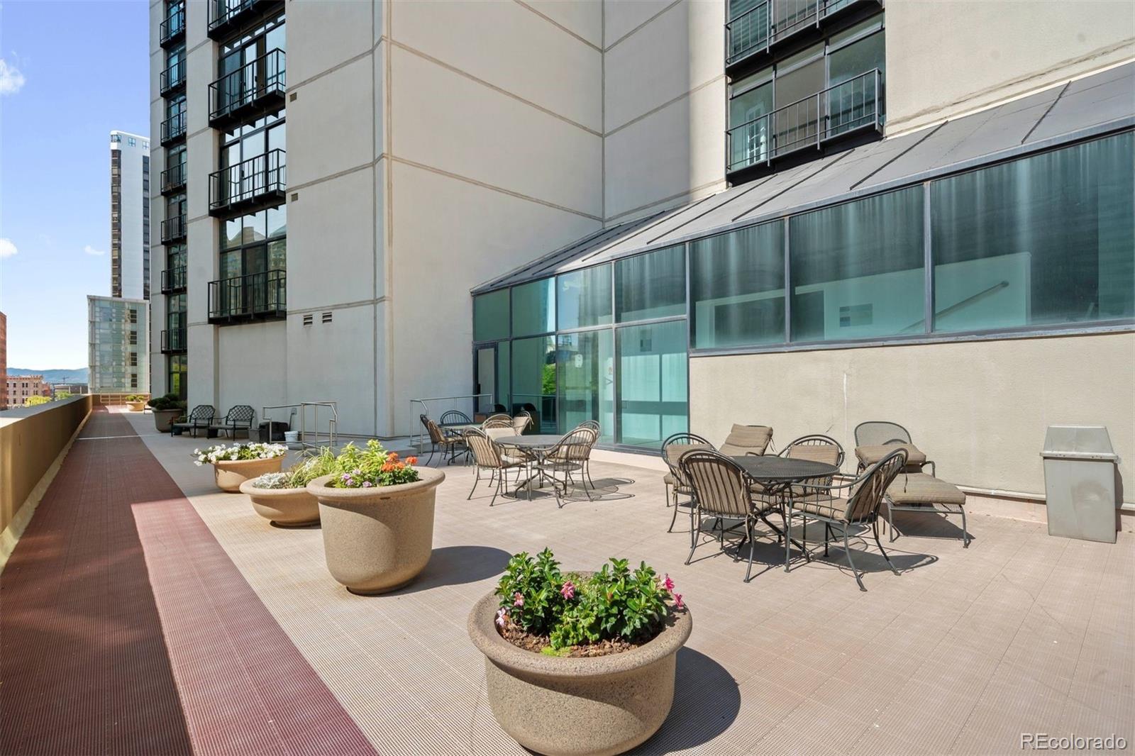 1777 Larimer Street, Unit 710 Denver, CO 80202 - Photo 45 of 47 a view of a patio with couches and potted plants