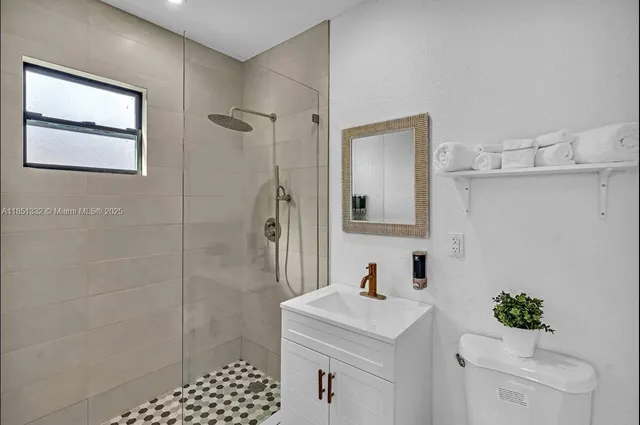 a bathroom with a sink toilet and shower