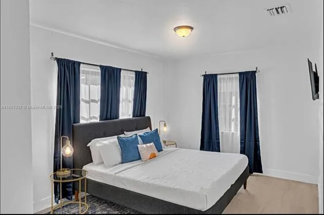 a bedroom with a bed and window