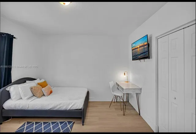 a bedroom with a bed and a lamp on table