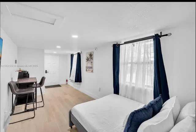 a bedroom with furniture and a window