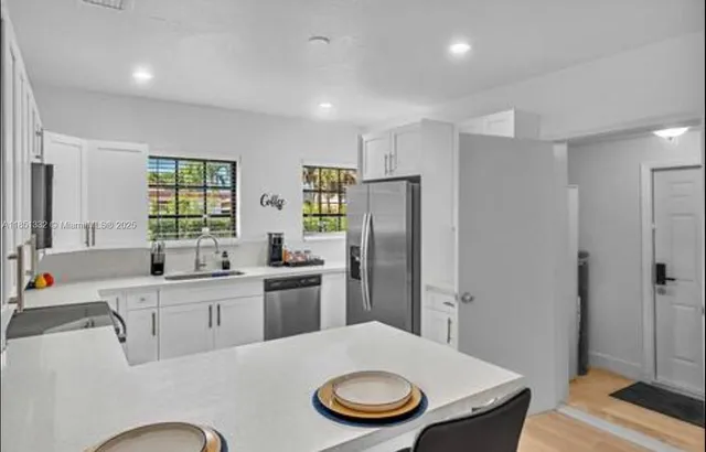 a kitchen with a refrigerator a sink and a stove