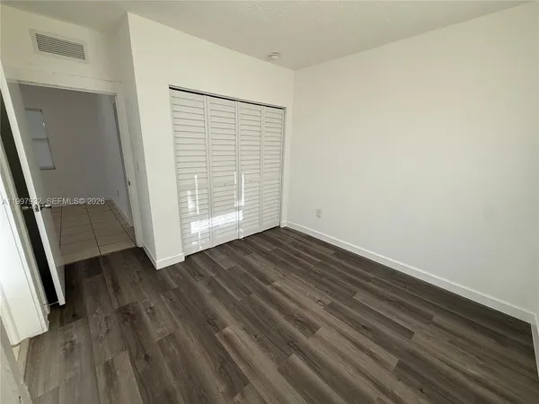 an empty room with wooden floor