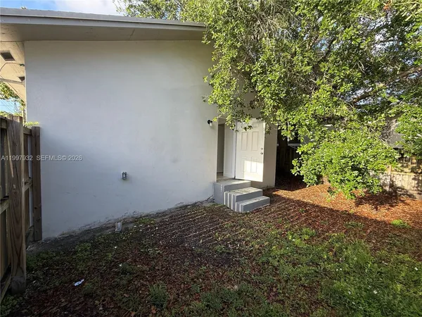 a view of a house with a tree