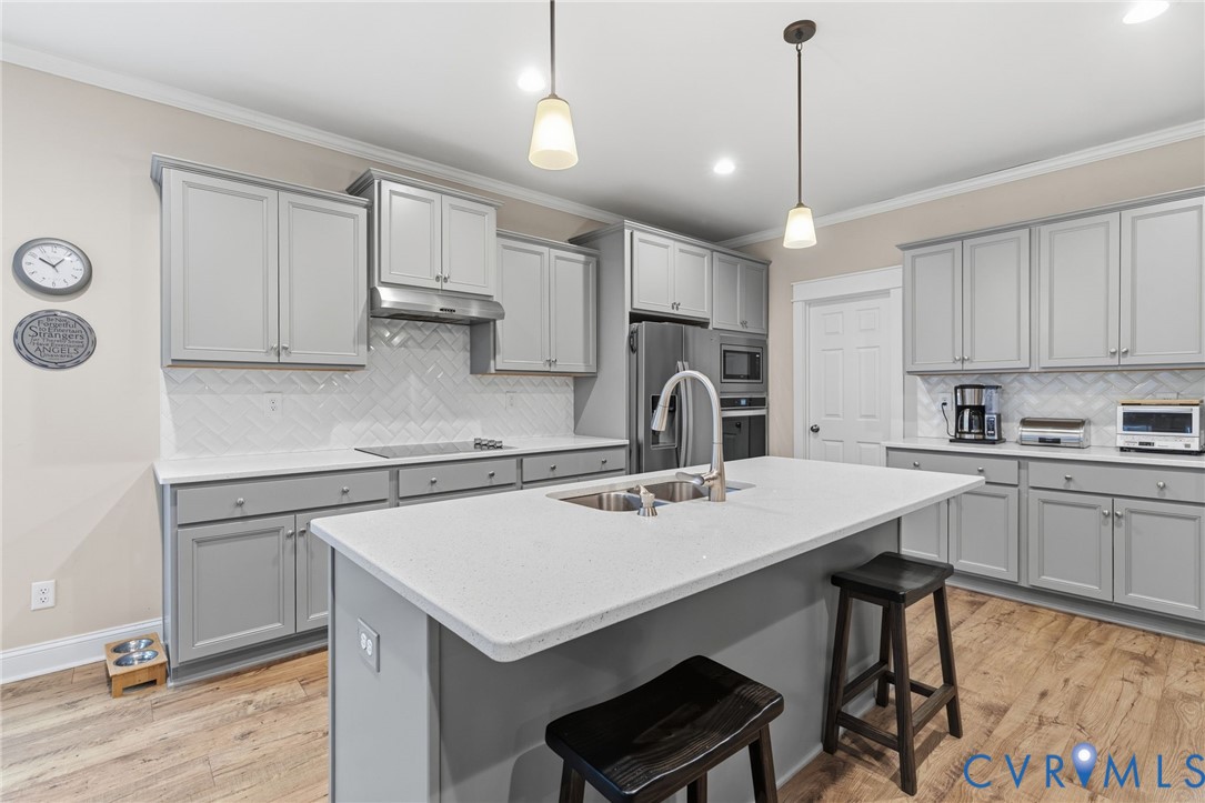 4001 Bircham Loop Midlothian, VA 23113 - Photo 6 of 33 a kitchen with a sink a stove a refrigerator and white cabinets with wooden floor