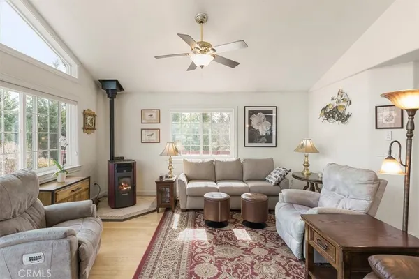 a living room with furniture and a large window with balcony view