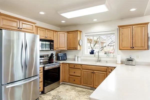 a kitchen with sink cabinets and window
