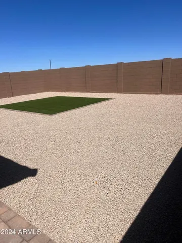 a view of a swimming pool with a yard