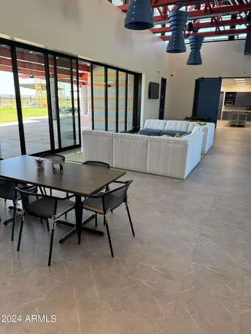 a living room with furniture and a floor to ceiling window