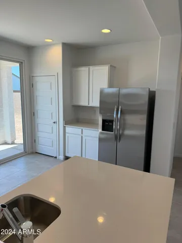 a view of a kitchen with white cabinets