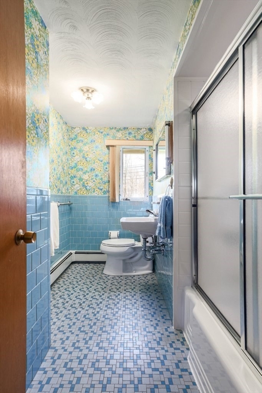 617 Edgell Road Framingham, MA 01701 - Photo 11 of 26 a bathroom with a toilet a sink and a mirror