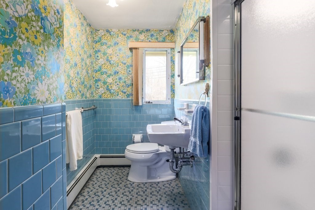 617 Edgell Road Framingham, MA 01701 - Photo 12 of 26 a bathroom with a toilet a sink and a mirror
