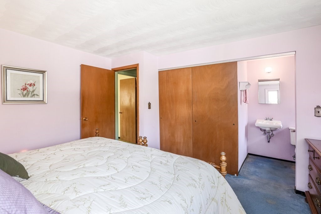 617 Edgell Road Framingham, MA 01701 - Photo 15 of 26 a bedroom with a bed and a walk in closet