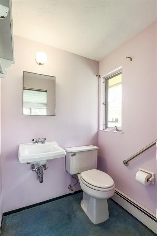 617 Edgell Road Framingham, MA 01701 - Photo 16 of 26 a bathroom with a toilet a sink and mirror