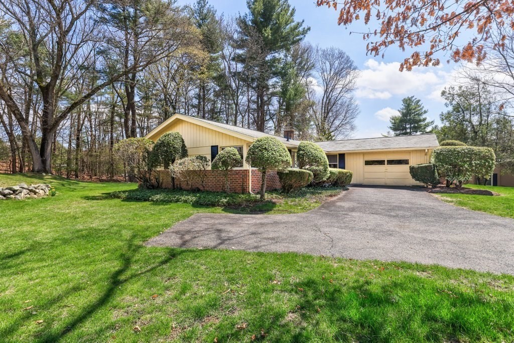 617 Edgell Road Framingham, MA 01701 - Photo 2 of 26 a view of a house with a small yard and large trees