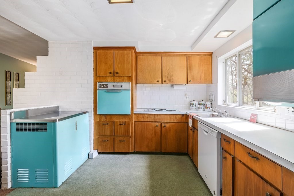 617 Edgell Road Framingham, MA 01701 - Photo 9 of 26 a kitchen with a sink cabinets and a window