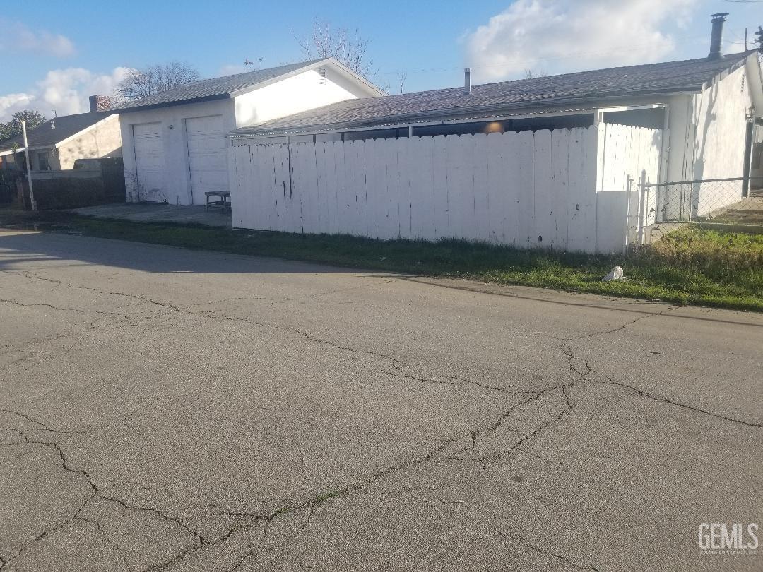 Undisclosed Address Bakersfield, CA 93304 - Photo 2 of 9 an empty room with a fireplace and windows