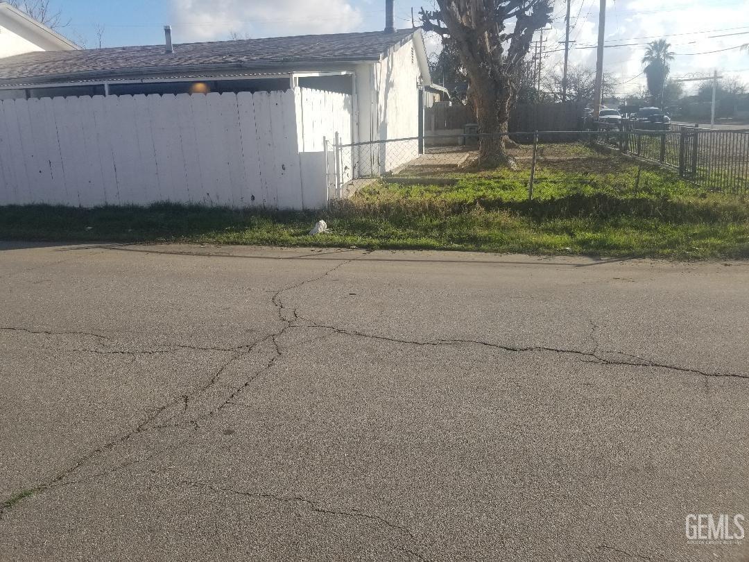 Undisclosed Address Bakersfield, CA 93304 - Photo 3 of 9 a front view of a house with a yard