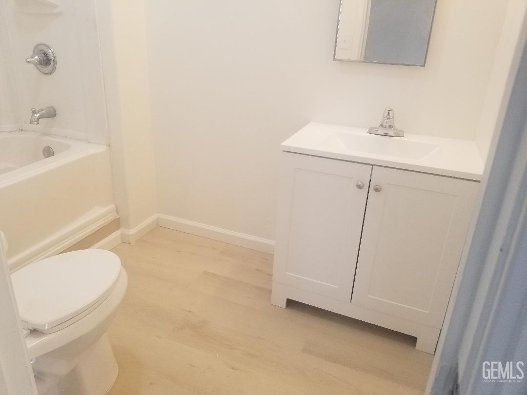 Undisclosed Address Bakersfield, CA 93304 - Photo 6 of 9 a bathroom with a sink a toilet and a mirror