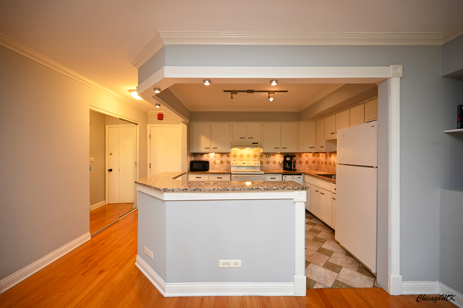 2234 South Goebbert Road, Unit 422 Arlington Heights, IL 60005 - Photo 6 of 27 a kitchen with stainless steel appliances granite countertop a sink and a refrigerator