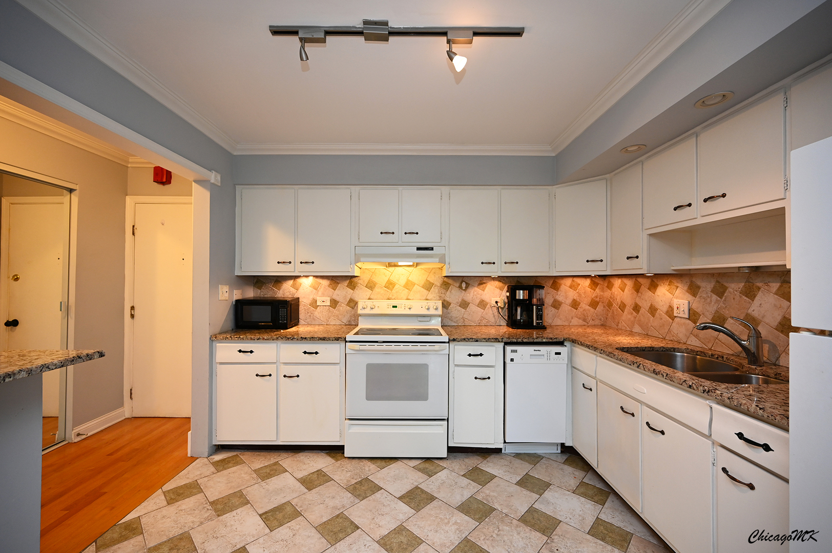 2234 South Goebbert Road, Unit 422 Arlington Heights, IL 60005 - Photo 7 of 27 a kitchen with a stove a sink and a refrigerator