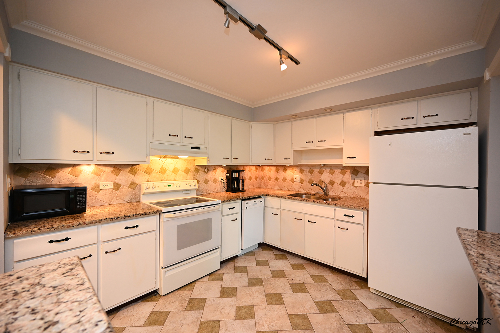 2234 South Goebbert Road, Unit 422 Arlington Heights, IL 60005 - Photo 8 of 27 a kitchen with white cabinets and white appliances