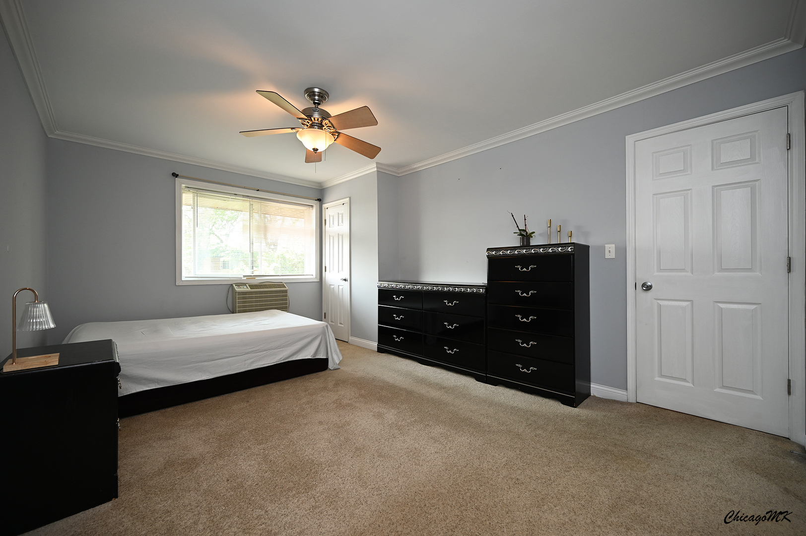 2234 South Goebbert Road, Unit 422 Arlington Heights, IL 60005 - Photo 10 of 27 a bedroom with a bed dresser and a window