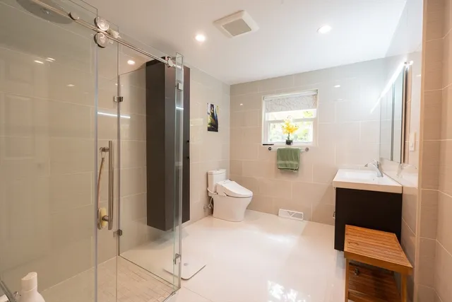 a bathroom with a shower and a glass door
