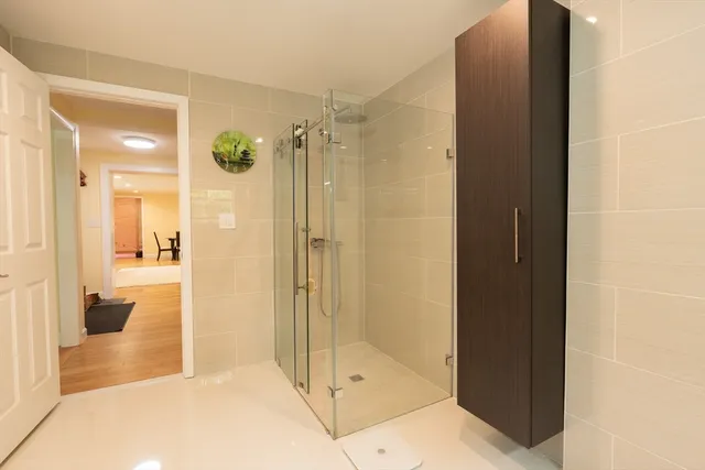 a bedroom with a bed and large windows